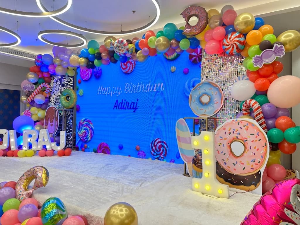Colorful donut and candy theme balloon backdrop for Adiraj's birthday
